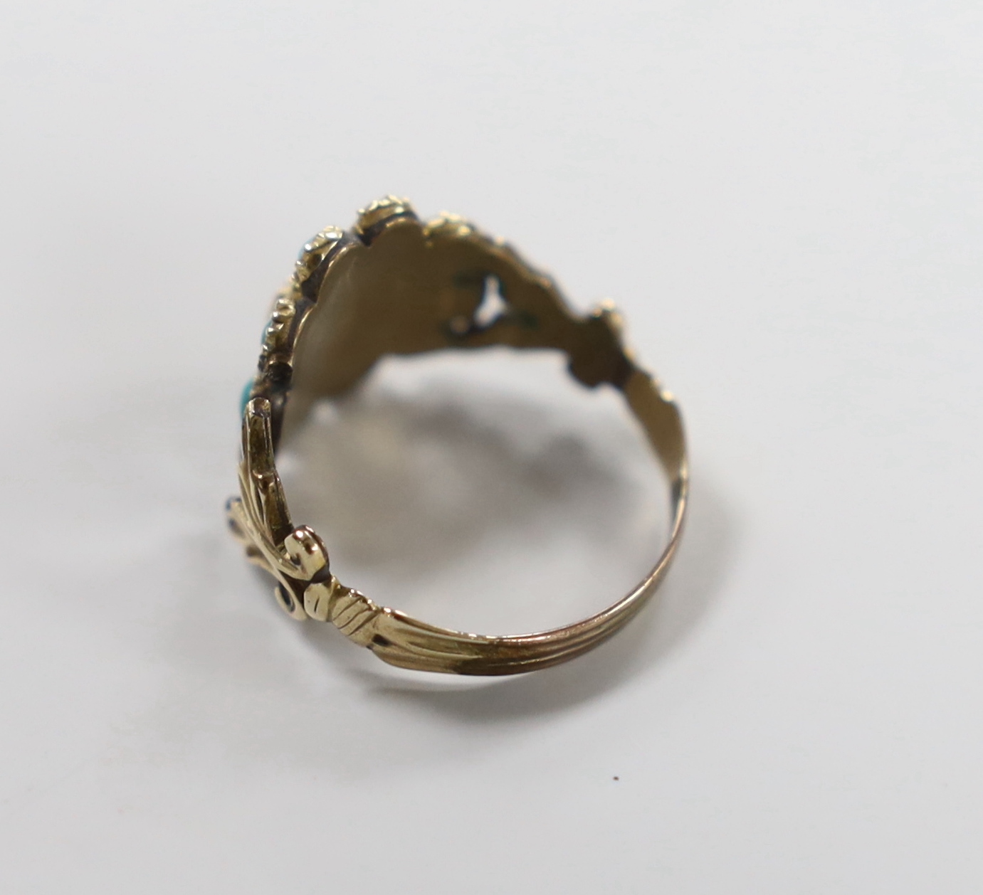 A Victorian yellow metal, foil backed garnet?, turquoise and seed pearl cluster set ring, (shank damaged), size M/N, gross weight 3.1 grams.
